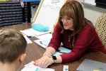 Meghan Durkee helps a student with their school work