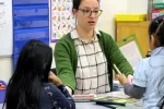 Maddie Geller works with students in a classroom