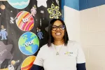 Jozette Hartsfield stands in front of a classroom door