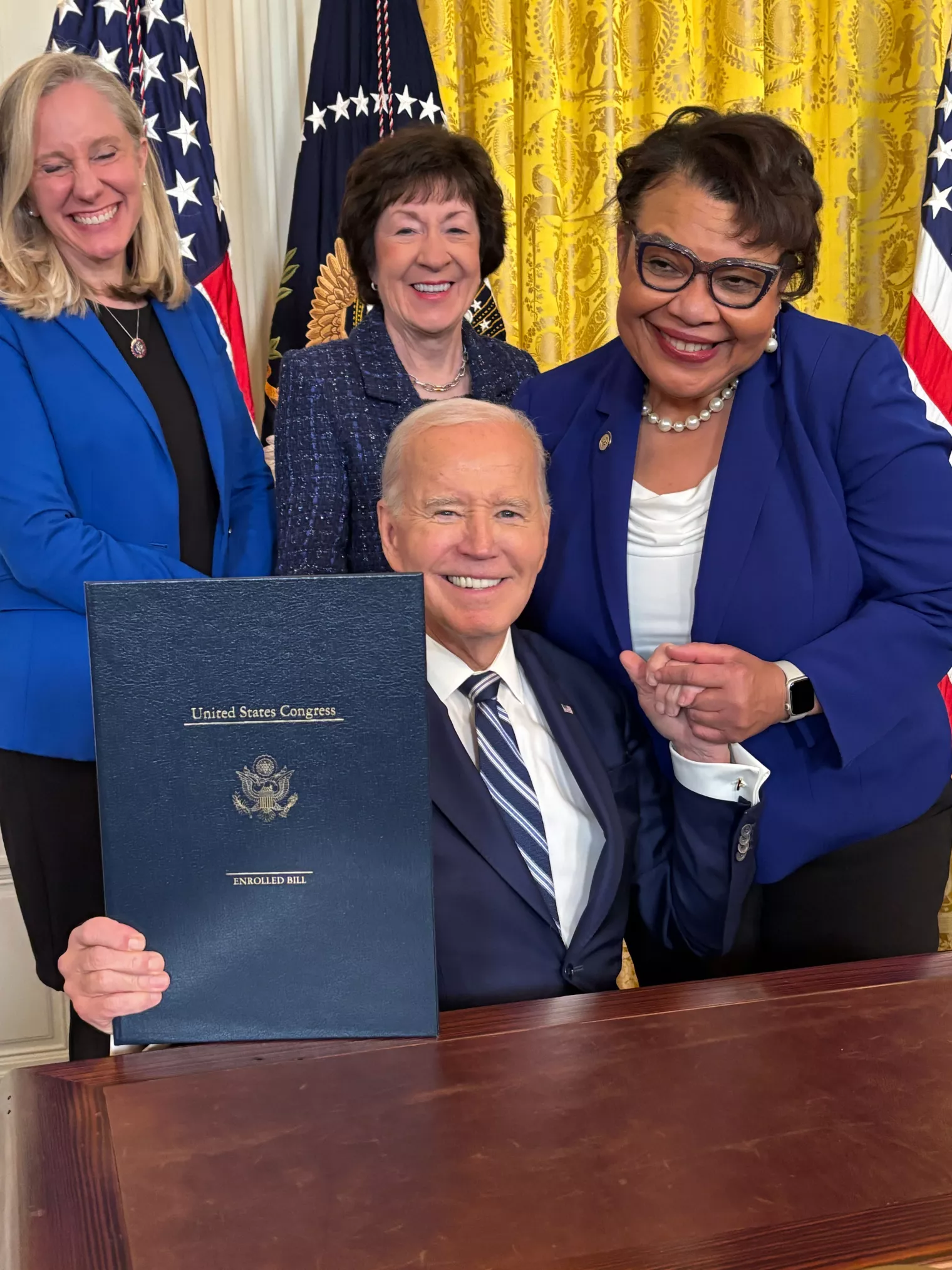 President Biden signs the Social Security Fairness law with NEA Vice President Princess Moss by his side