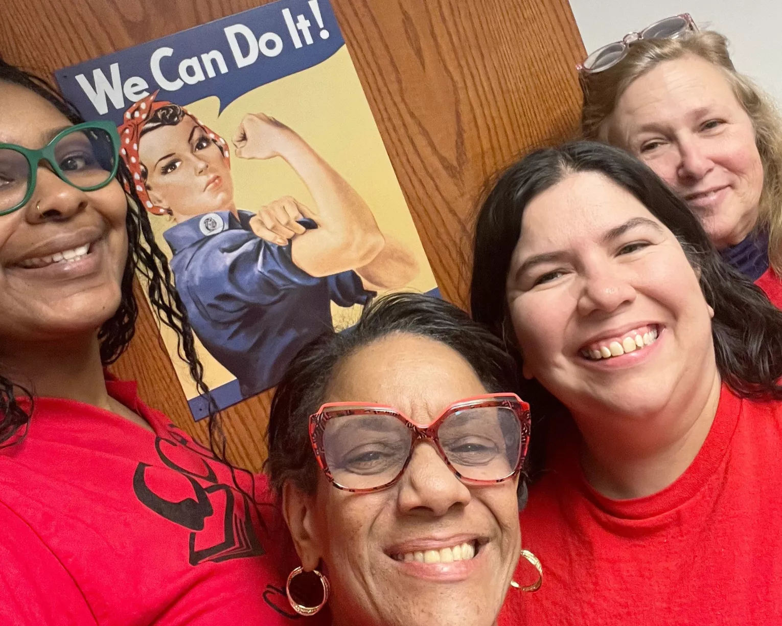 members in red for Ed with a "We Can Do It!" poster