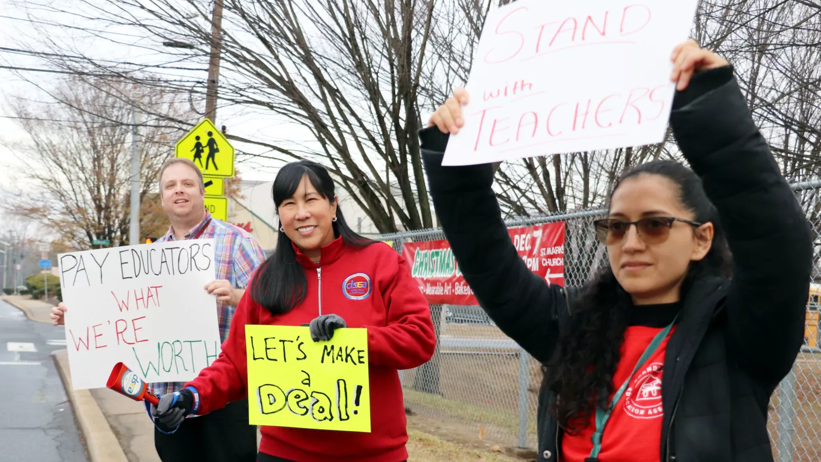 Brandywine Education Association members picketing with signs that say "pay educators what we're worth," "let's make a deal," "stand with teachers."