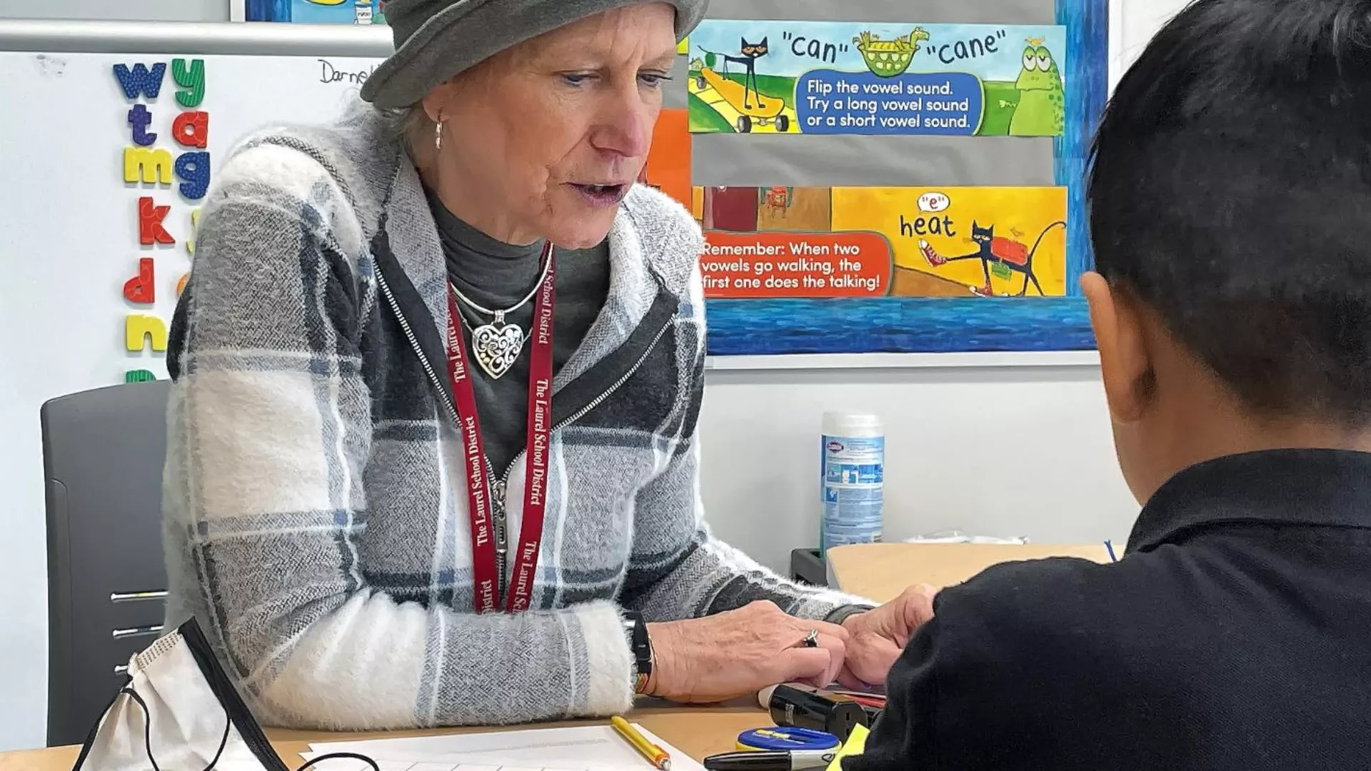 Sue Darnell helps a student with their class work
