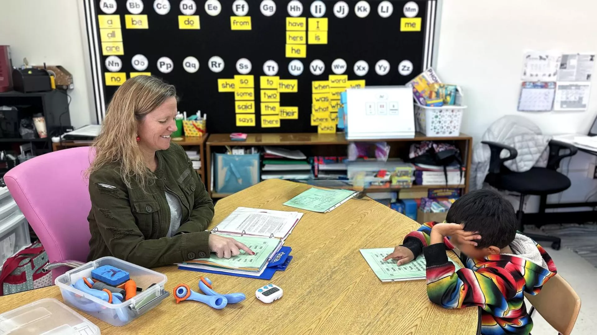 Cassie Queen helps a student with their class work