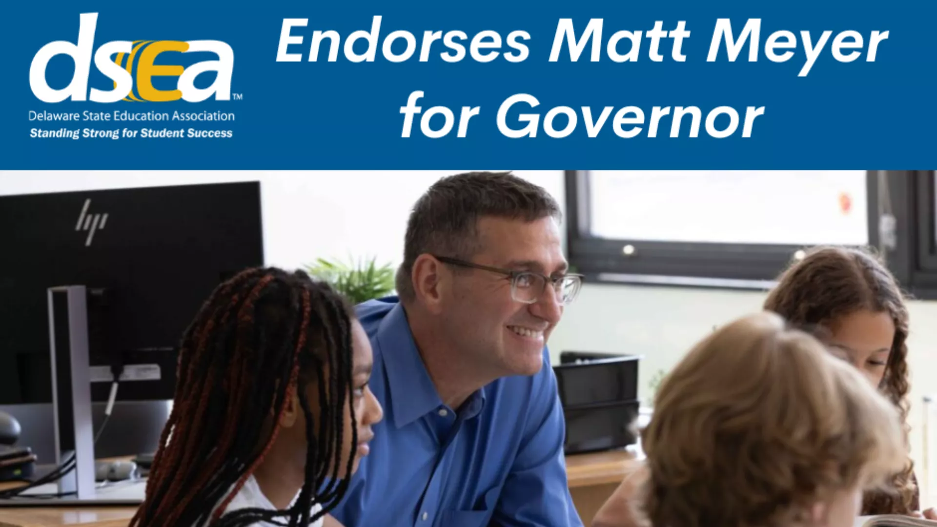 Matt Meyer sits with students