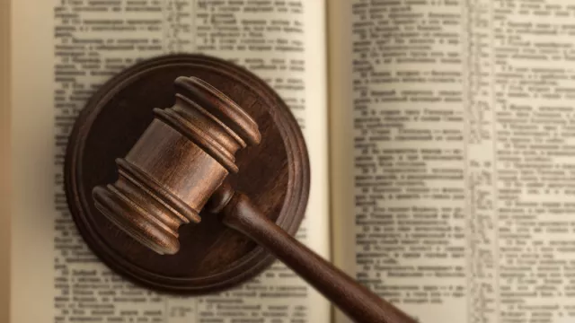 a picture of a wooden gavel on legal text