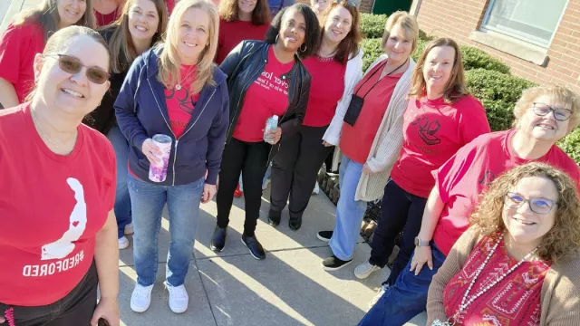 teachers at the March 2025 walk-in dressed in red